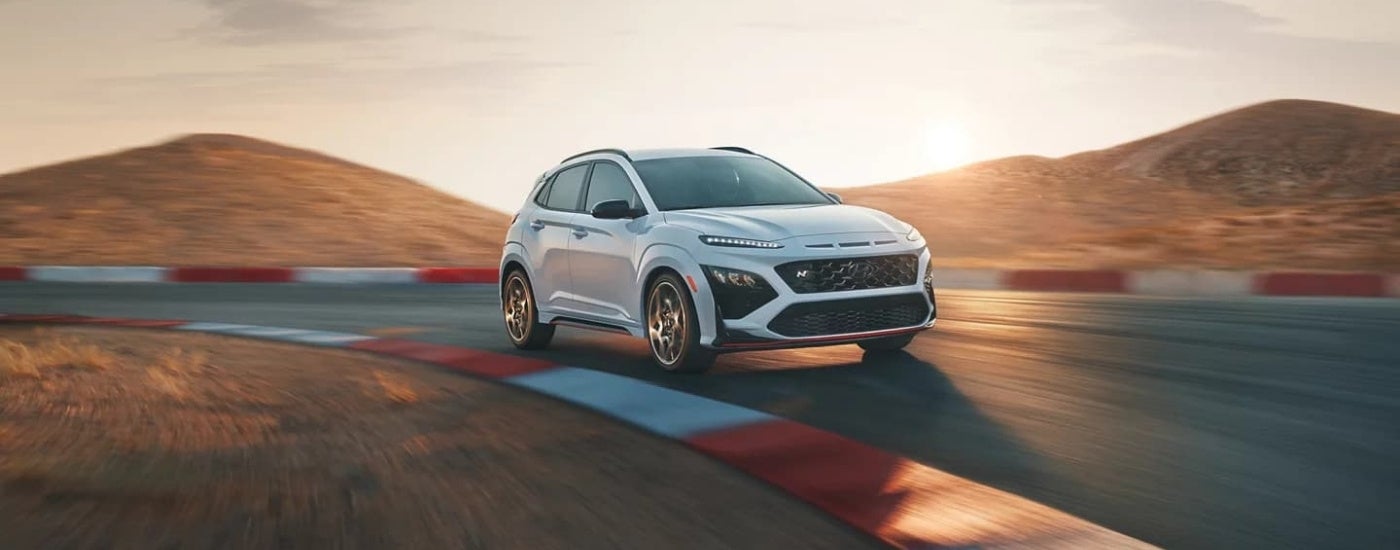 White 2022 Hyundai Kona N driving on a racetrack