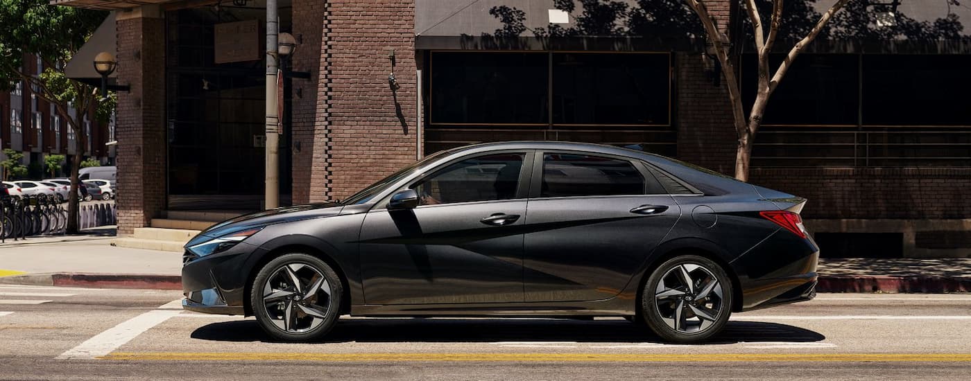 Side of a grey 2021 Hyundai Elantra on a city street