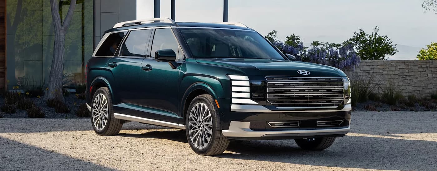 A blue 2026 Hyundai Palisade parked in a driveway