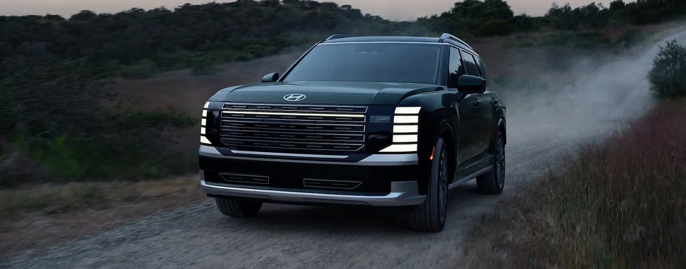 A blue 2026 Hyundai Palisade off-roading on a trail